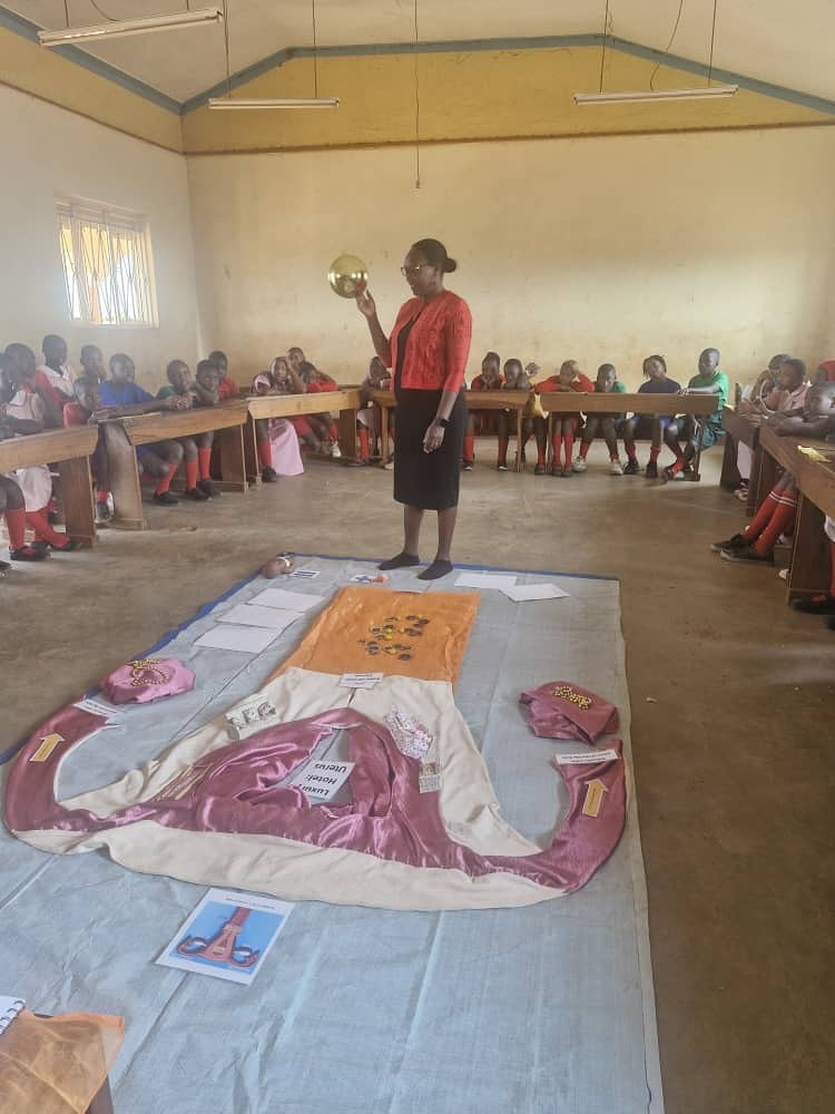 Teacher educating students using a large fabric model of the female reproductive system.