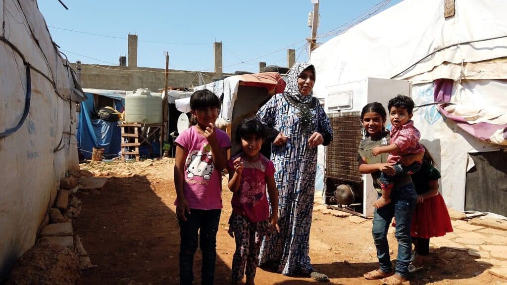 Syrische Flüchtlingsfamilie in provisorischem Lager. Frau mit Kindern.